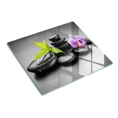 Glass kitchen board Stones and orchid on the background