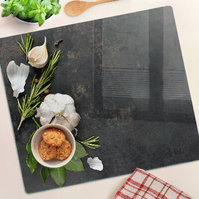 Glass chopping board Flowers and herbs on a marble background