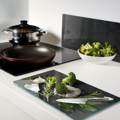 Glass chopping board Flowers and herbs on a marble background