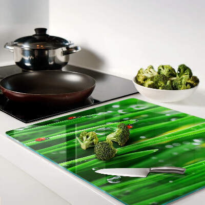Glass kitchen board Water drops on grass with ladybugs