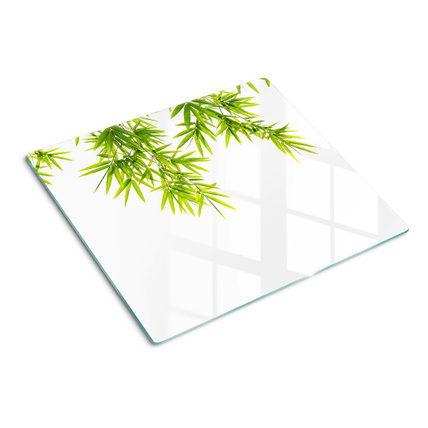 Glass chopping board Bamboo leaves on the window background