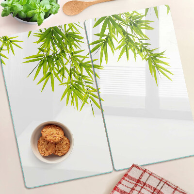 Glass chopping board Bamboo leaves on the window background