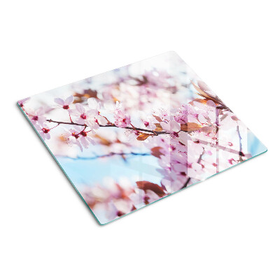 Glass kitchen board Cherry blossoms on a blue background