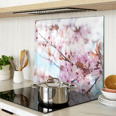 Glass kitchen board Cherry blossoms on a blue background