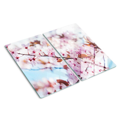 Glass kitchen board Cherry blossoms on a blue background
