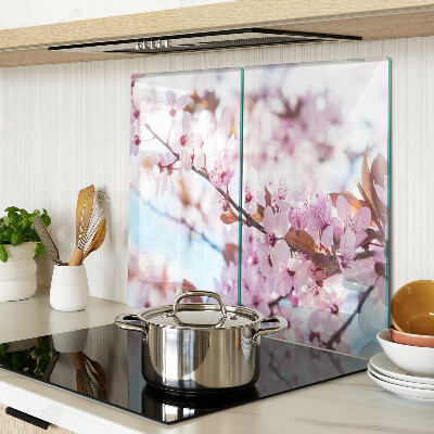 Glass kitchen board Cherry blossoms on a blue background