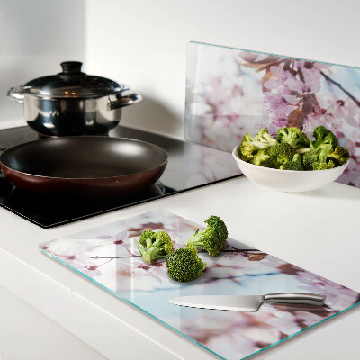 Glass kitchen board Cherry blossoms on a blue background