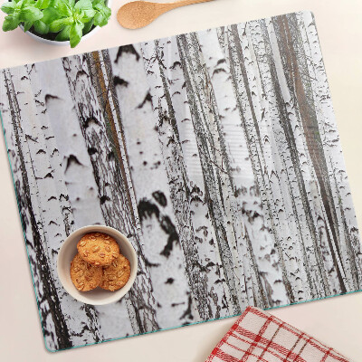 Glass chopping board White trunks of birch trees