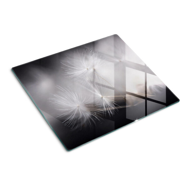 Glass kitchen board Fluffy dandelions against the window background