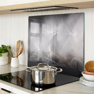 Glass kitchen board Fluffy dandelions against the window background