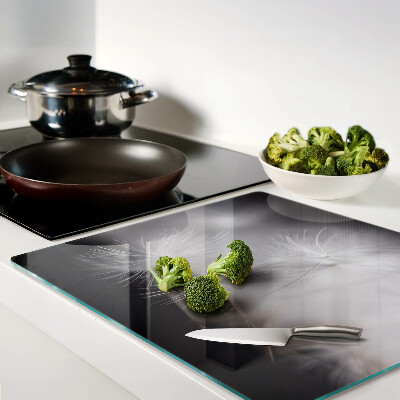 Glass kitchen board Fluffy dandelions against the window background