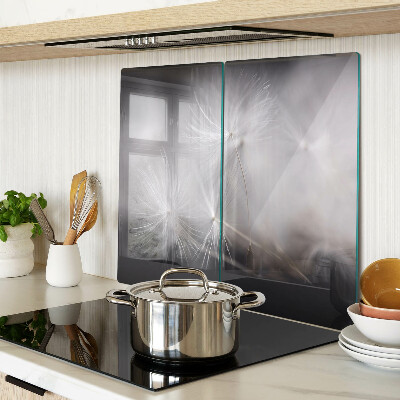 Glass kitchen board Fluffy dandelions against the window background