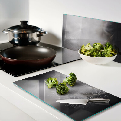 Glass kitchen board Fluffy dandelions against the window background