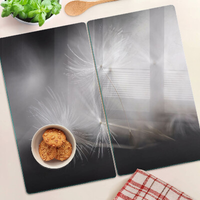 Glass kitchen board Fluffy dandelions against the window background