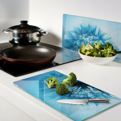 Glass chopping board Dandelion on a blue background