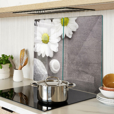 Glass chopping board Flowers and stones on the background
