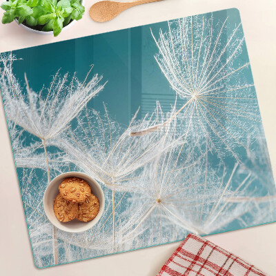 Glass chopping board Dandelions on a blue background