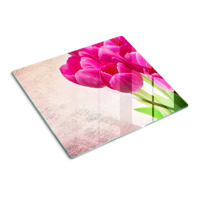 Glass kitchen board Tulip flowers on a pink background