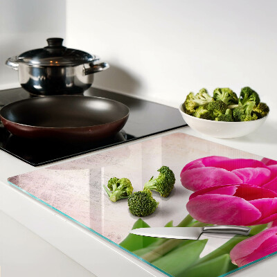 Glass kitchen board Tulip flowers on a pink background