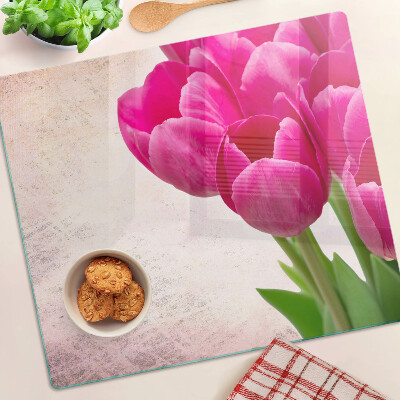 Glass kitchen board Tulip flowers on a pink background