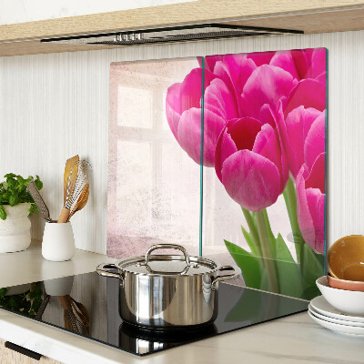 Glass kitchen board Tulip flowers on a pink background