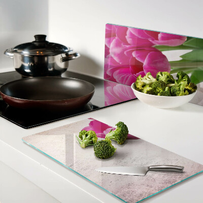 Glass kitchen board Tulip flowers on a pink background