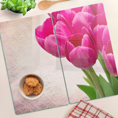 Glass kitchen board Tulip flowers on a pink background