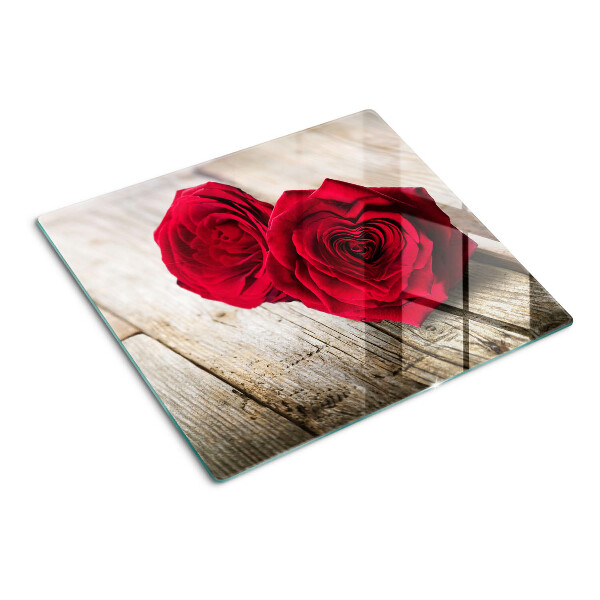 Glass kitchen board Red roses on a wooden background