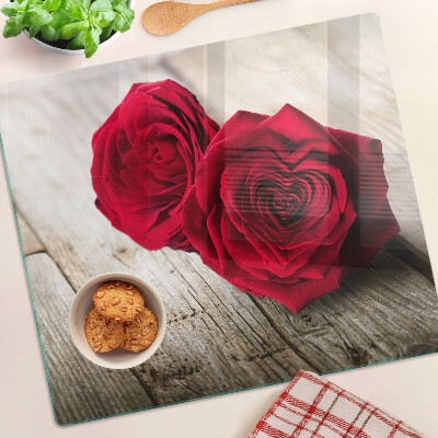 Glass kitchen board Red roses on a wooden background