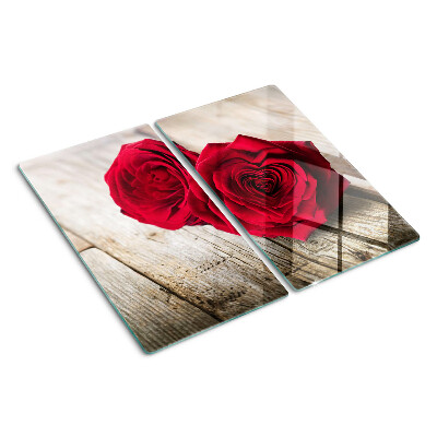 Glass kitchen board Red roses on a wooden background