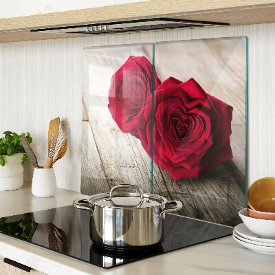 Glass kitchen board Red roses on a wooden background