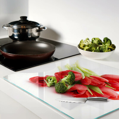 Glass kitchen board Red tulips on a white background