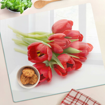 Glass kitchen board Red tulips on a white background