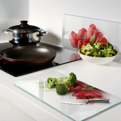 Glass kitchen board Red tulips on a white background