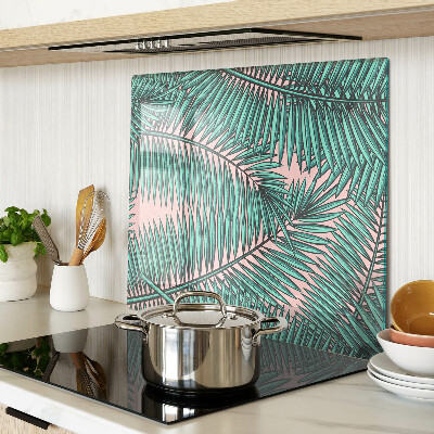 Glass kitchen board Palm leaves on a pink background