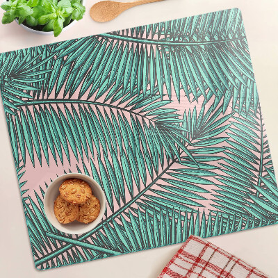 Glass kitchen board Palm leaves on a pink background