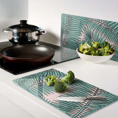 Glass kitchen board Palm leaves on a pink background