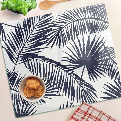 Glass chopping board Palm leaves on a white background