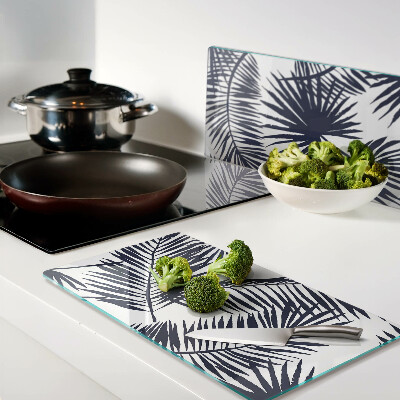Glass chopping board Palm leaves on a white background
