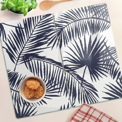Glass chopping board Palm leaves on a white background