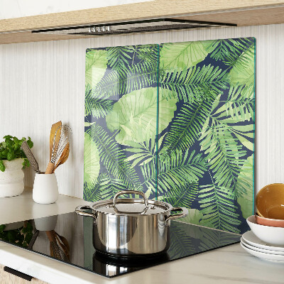 Glass chopping board Tropical leaves on a dark background