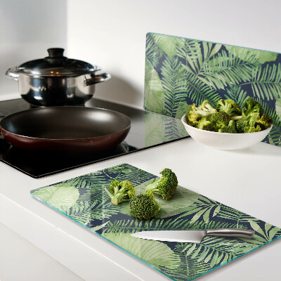 Glass chopping board Tropical leaves on a dark background