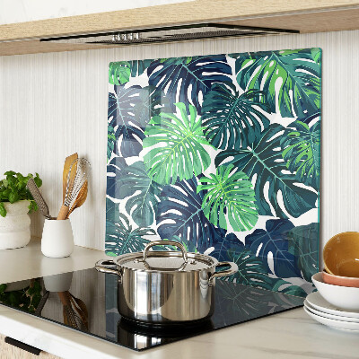 Glass kitchen board Monstera leaves on a tropical background