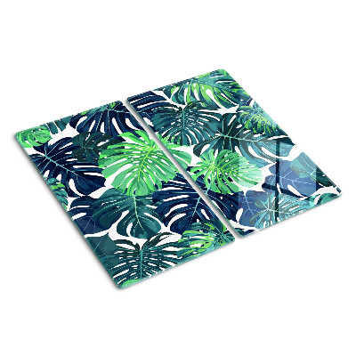 Glass kitchen board Monstera leaves on a tropical background