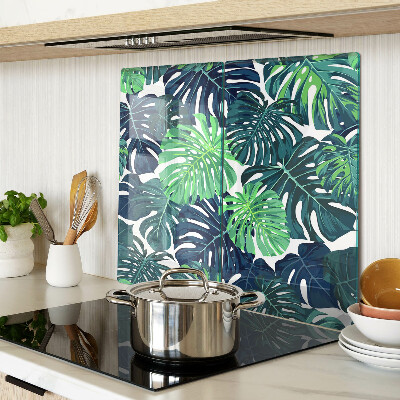 Glass kitchen board Monstera leaves on a tropical background