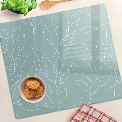 Glass chopping board Leaves on the background