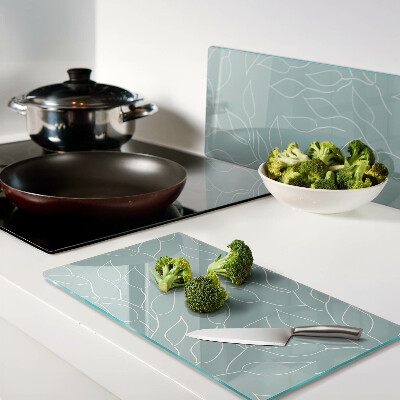 Glass chopping board Leaves on the background