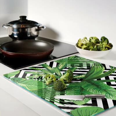 Glass kitchen board Tropical leaves on stripes