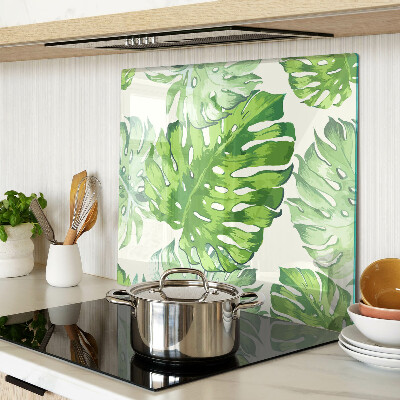 Glass kitchen board Monstera leaves on a light background