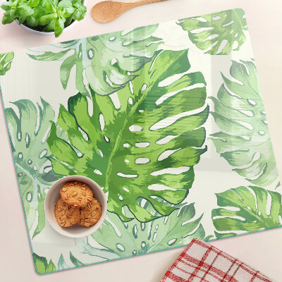 Glass kitchen board Monstera leaves on a light background